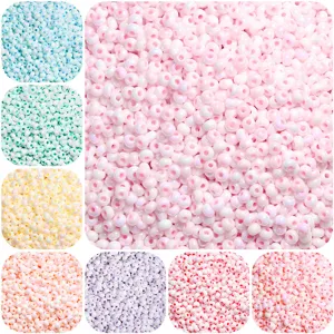 Gros plan de diverses perles de rocaille en céramique nacrée pastel pour la création de bijoux