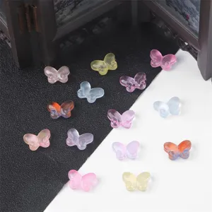 Macro view of various colorful transparent glass butterfly beads for DIY handmade jewelry