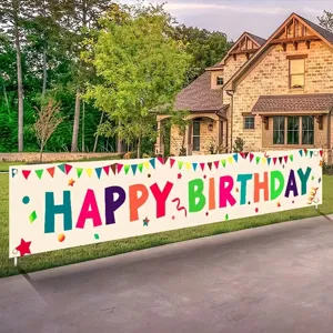 Large colorful Happy Birthday yard banner displayed in front of a house driveway