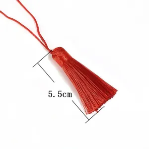 Detail showing a 5.5cm handmade red tassel for DIY bookmark and fan decoration