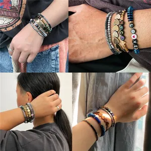 Detailed view of multi-layered beaded bracelets featuring heart and star designs