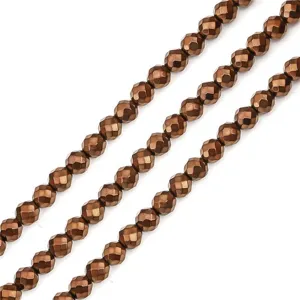 Close-up macro view of faceted metallic bronze hematite beads for DIY handmade jewelry crafts