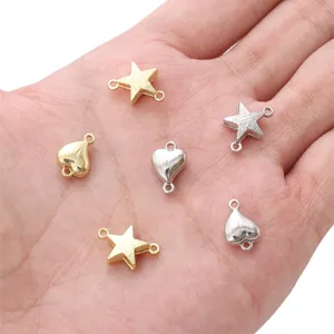 Close-up of star and heart shaped magnetic clasps for DIY jewelry making on a hand