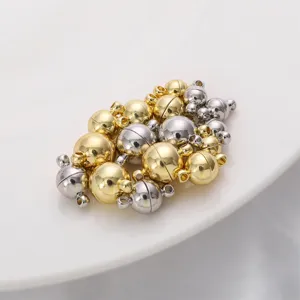Detail view of gold and silver plated spherical magnetic clasps for DIY jewelry making