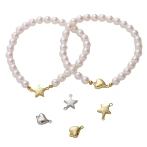 Detail view of heart and star shaped magnetic clasps for DIY pearl bracelet connectors
