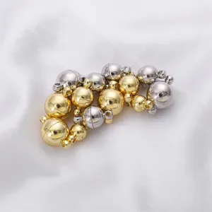 Close-up of gold and silver spherical magnetic clasps for DIY jewelry making
