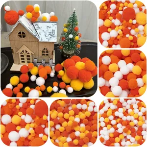 Collage aus orangefarbenen, gelben und weißen Plüschbommeln für DIY-Bastelarbeiten.