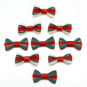 Detailed view of handmade striped ribbon bows in festive red and green for DIY hair crafts