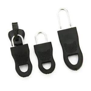 Vue détaillée de trois tirettes de fermeture éclair noires amovibles
