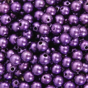 Macro view of vibrant purple pearl beads for DIY jewelry making and crafting.