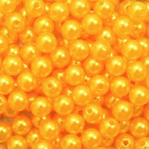 Macro view showing the bright orange ABS acrylic pearl beads with pre-drilled holes