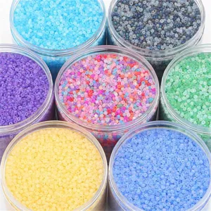 Top view of colorful frosted glass seed beads in clear jars for DIY jewelry making