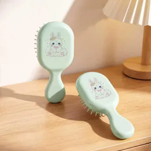 Close-up of cute cartoon bunny printed air cushion hair brushes on a wooden table
