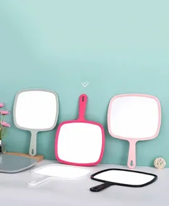Detailed view of large handheld makeup mirrors in multiple colors with hanging handles