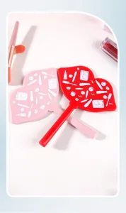 Detail showing the cute white cosmetic patterns on the back of red and pink lip mirrors.