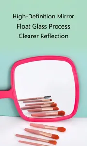 Detail shot of pink handheld mirror reflecting set of makeup brushes on white background