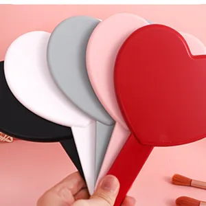 Colorful heart-shaped handheld mirrors for professional makeup in various shades