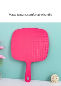 Detail view of the quilted back on a large pink hand-held mirror with hangable handle.