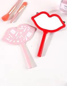 Creative lip-shaped handheld makeup mirrors in red and pink with makeup brush details