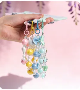 Detail of pastel beaded charms for handheld mirrors in pink, yellow, blue, and green colors.