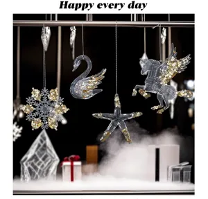 Clear acrylic Christmas ornaments filled with gold sequins in swan and snowflake shapes.
