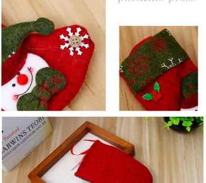 Detail macro view of a red felt Christmas stocking with snowflake and snowman embroidery