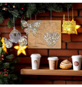 Detail of transparent acrylic Christmas ornaments with sparkling gold sequins hanging on tree.