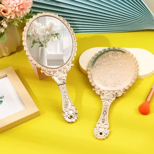 Vintage rose gold handheld mirror with elegant engraved pattern for makeup.