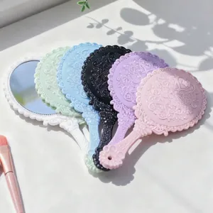 Elegant vintage style plastic hand mirrors with embossed floral pattern in assorted colors