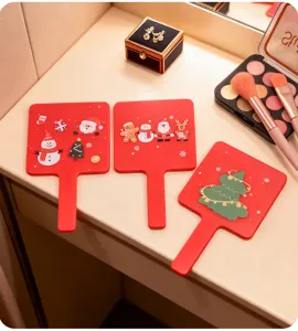 Detail of red handheld makeup mirrors featuring festive Christmas character decorations