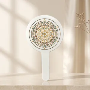 Back view of handheld mirror featuring a vintage Chinese floral mandala pattern.