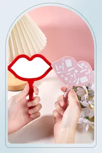 Creative lip-shaped handheld makeup mirrors in red and pink with decorative patterns