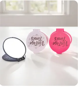 Detailed view of portable folding mirrors in vibrant pink, white, and black dopamine colors.