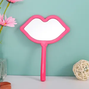 Close-up of a pink lip-shaped handheld makeup mirror for daily touch-ups