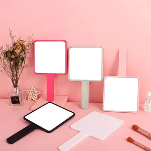 Large square handheld makeup mirror with ergonomic handle available in multiple colors