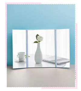 Lifestyle view of a white trifold tabletop makeup mirror reflecting elegant home decor