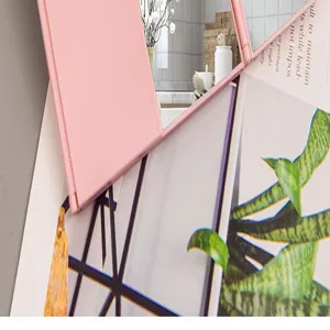 Detailed close-up view of a pink foldable three-way makeup mirror with glass surface detail