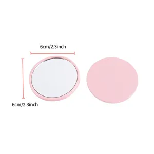 Small pink portable round makeup mirror shown with 6cm and 2.3 inch diameter dimensions