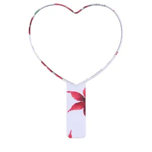 Portable heart-shaped handheld makeup mirror with floral print for daily beauty needs