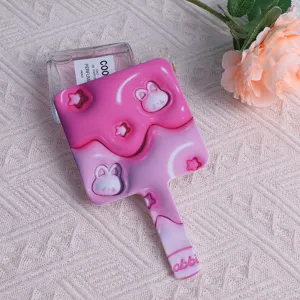 Detail of a cute pink square handheld makeup mirror with rabbit and star patterns.
