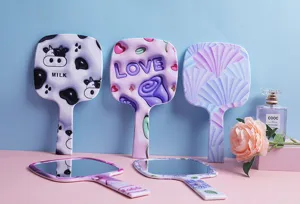 Colorful portable handheld makeup mirrors with cow print, heart, and floral patterns