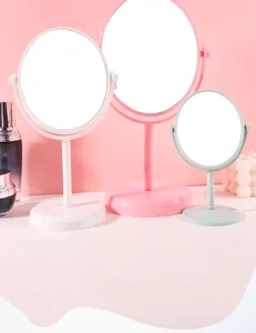 Set of three rotating plastic desktop makeup mirrors in pastel white, pink and green