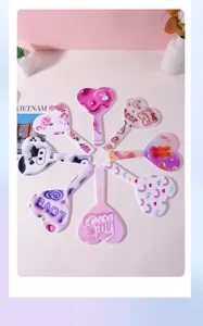 Macro view of various colorful heart-shaped hand mirrors with cute patterns