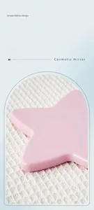 Detailed view showing the smooth polished edges of a pink star-shaped handheld mirror.