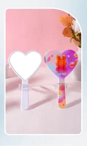 Detailed view of front and colorful bunny-pattern back of heart-shaped hand mirrors.
