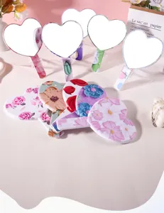 Assorted floral patterns on the backs of heart-shaped portable handheld makeup mirrors