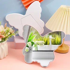 Aesthetic butterfly-shaped desktop makeup mirror with pink irregular frame for vanity.