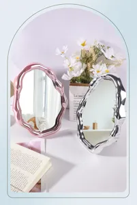 Close-up of irregular cloud makeup mirrors with electroplated pink and silver wavy frames.
