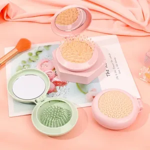 Portable folding air cushion hairbrush with integrated mirror in cute pink and green