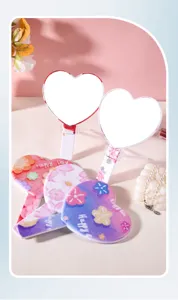 Detail view of heart-shaped handheld mirrors with colorful floral designs and prints
